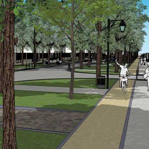 Vue d'un boulevard à Soissons, montrant une large allée bordée d'arbres et de lampadaires. Des personnes se promènent et font du vélo sur un chemin pavé. Des espaces verts avec de l'herbe et des zones de repos sont visibles de part et d'autre du boulevar