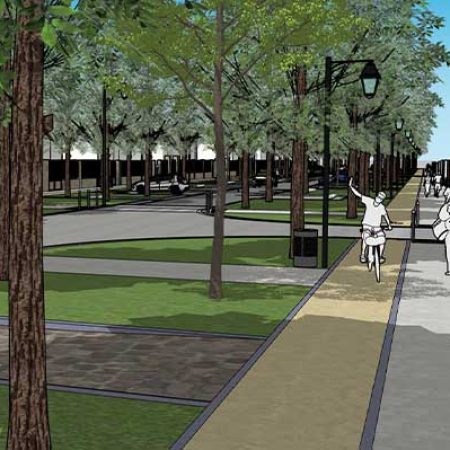 Vue d'un boulevard à Soissons, montrant une large allée bordée d'arbres et de lampadaires. Des personnes se promènent et font du vélo sur un chemin pavé. Des espaces verts avec de l'herbe et des zones de repos sont visibles de part et d'autre du boulevar